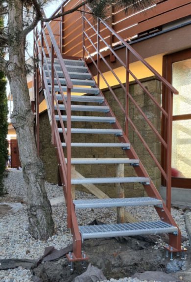 schody so schodnicami z protišmykových roštov s hnedým zábradlím